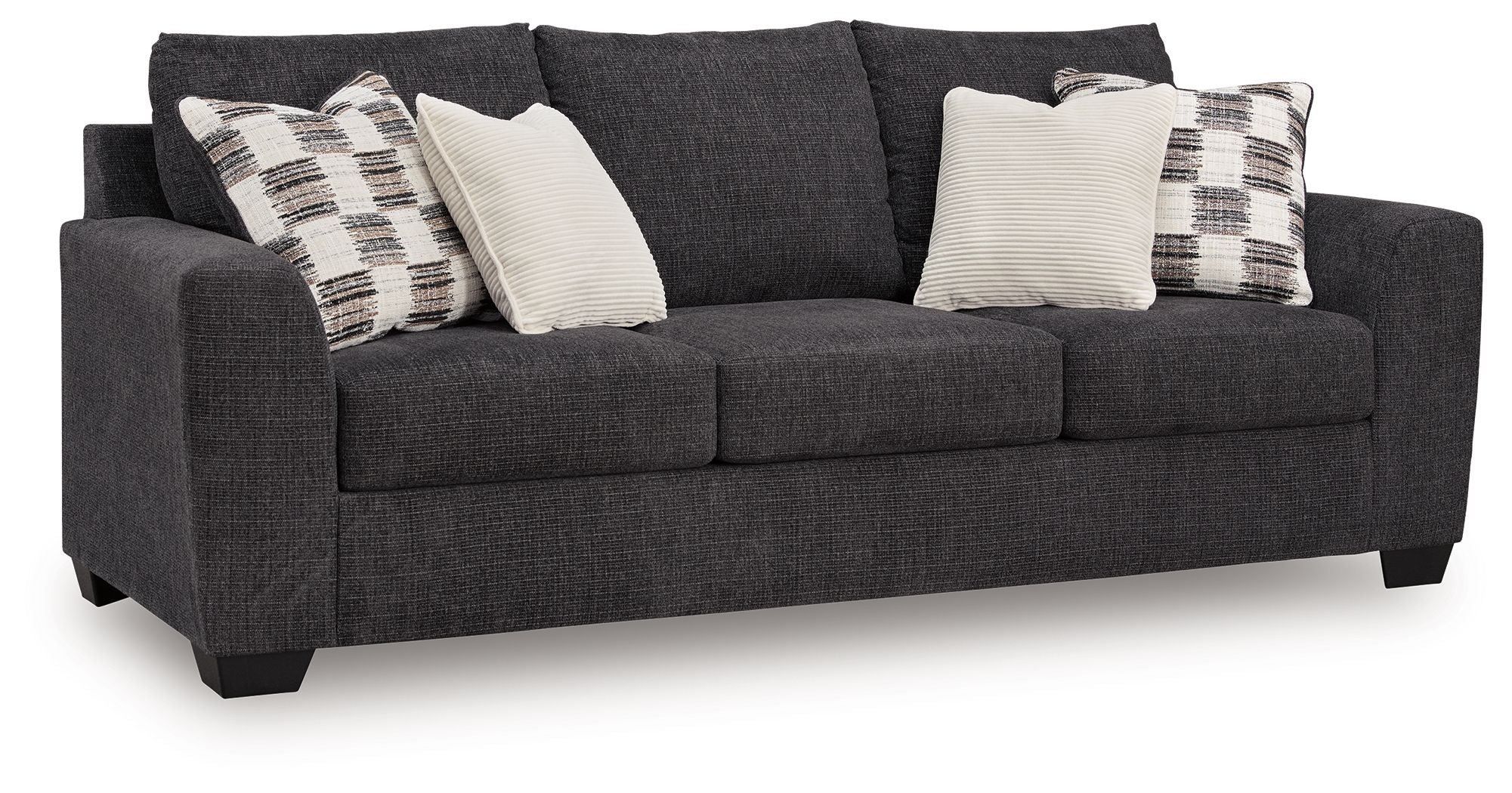 Sofa sleeper, dark gray upholstery with plaid and white throw pillows.