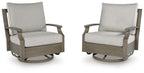 Pair of swivel glider chairs with light beige cushions and dark brown frames