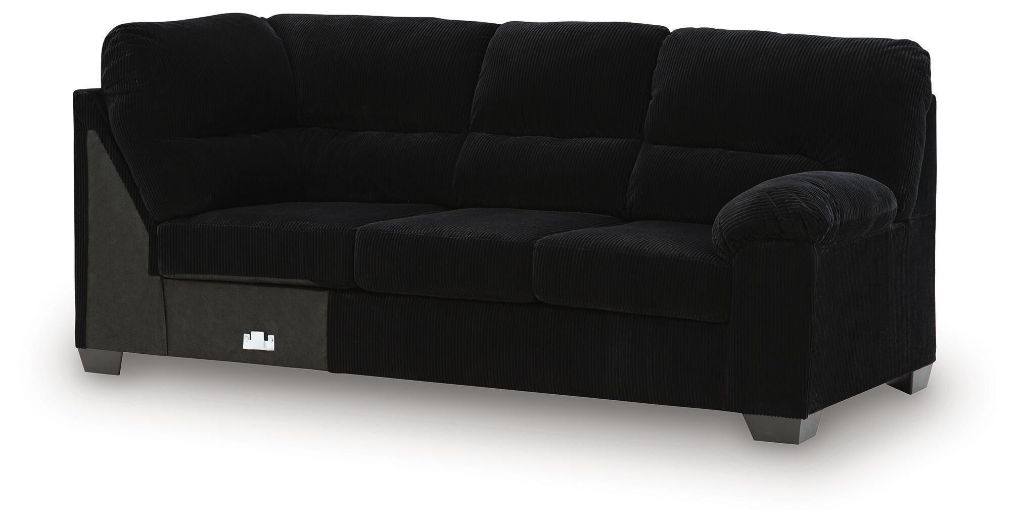 Dark fabric sofa with corner wedge, rounded arms, cushioned back and seat