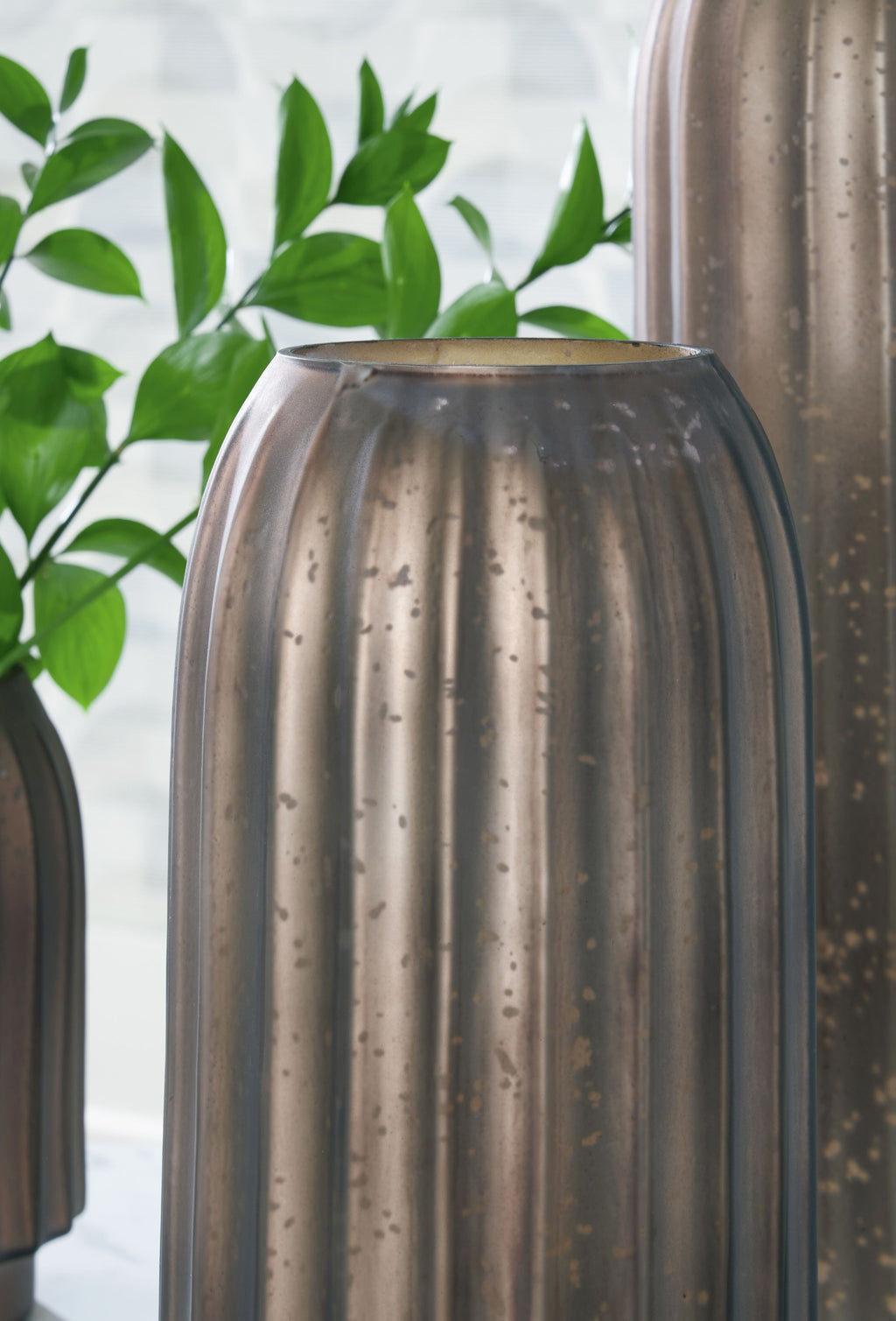 Metal vase with dark bronze fluted sides and wide top rim