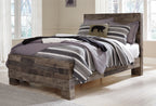 Rustic panel bed with dark wood frame and striped bedding with gray and black layers