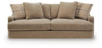 Sofa with light beige fabric and plaid accent pillows on the backrest