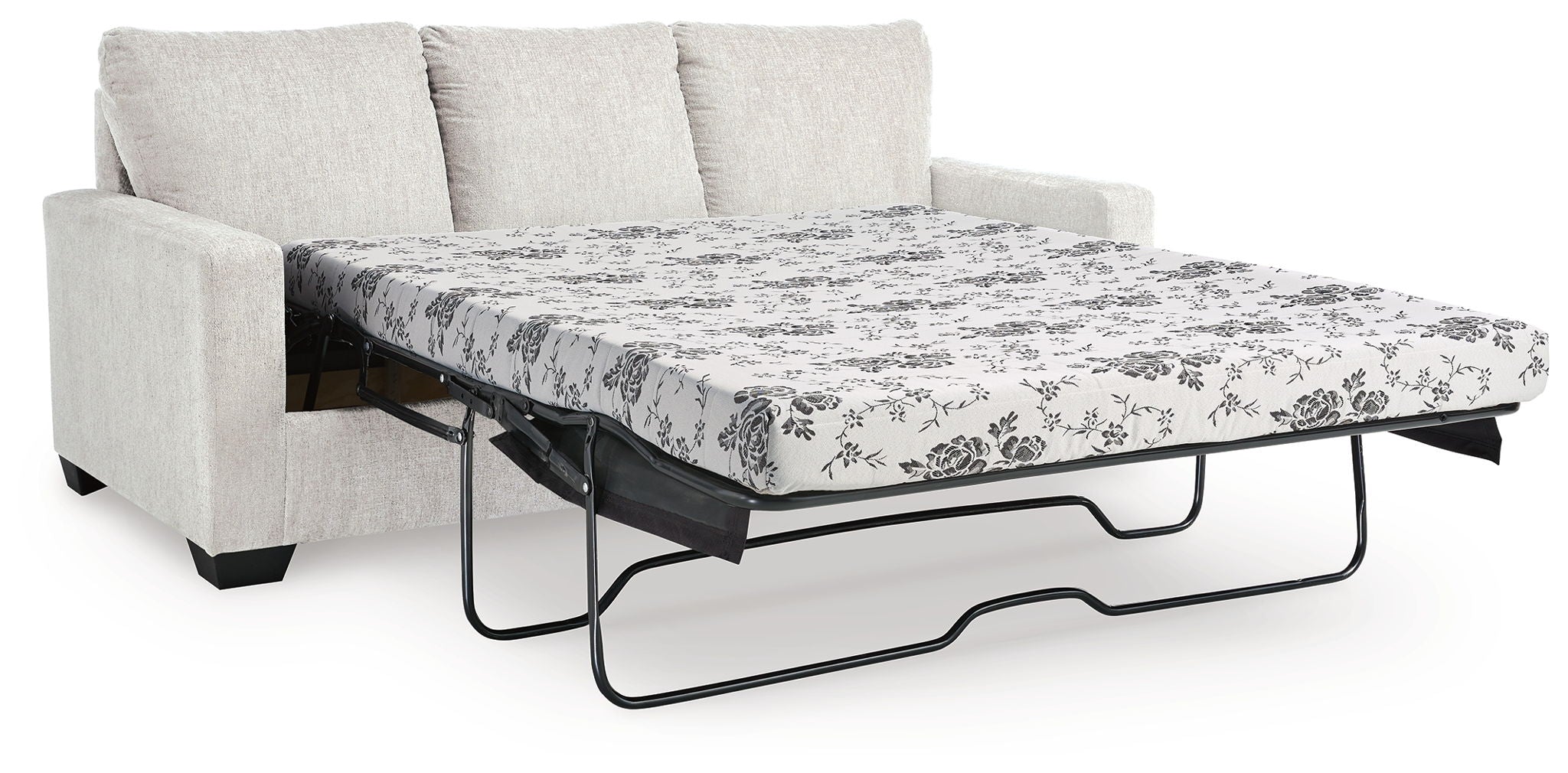 Beige sofa bed with pulled-out mattress and floral patterned cover