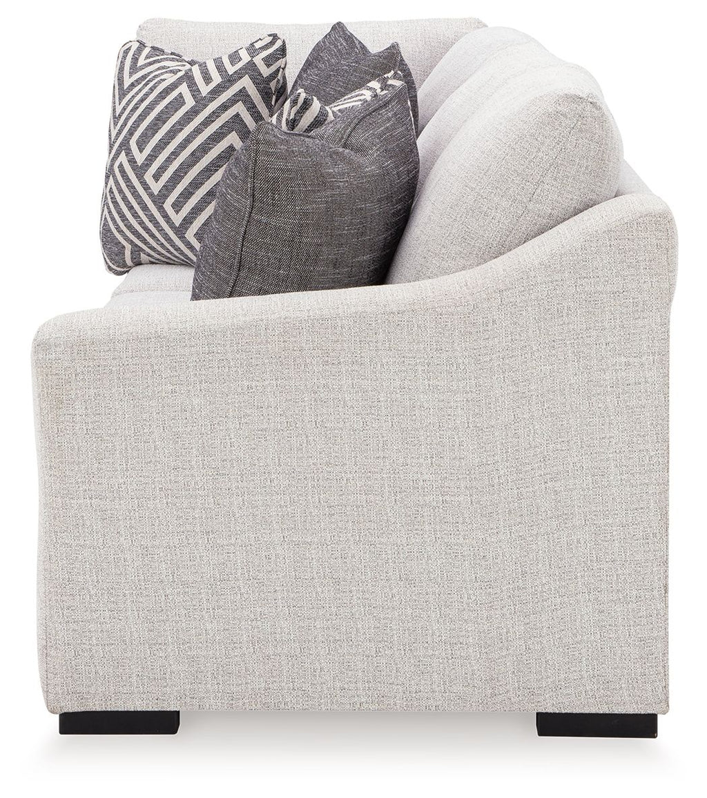 Koralynn Raf sofa arm in light gray fabric with dark legs and decorative pillows