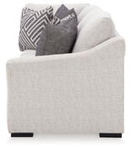 Koralynn Raf sofa arm in light gray fabric with dark legs and decorative pillows