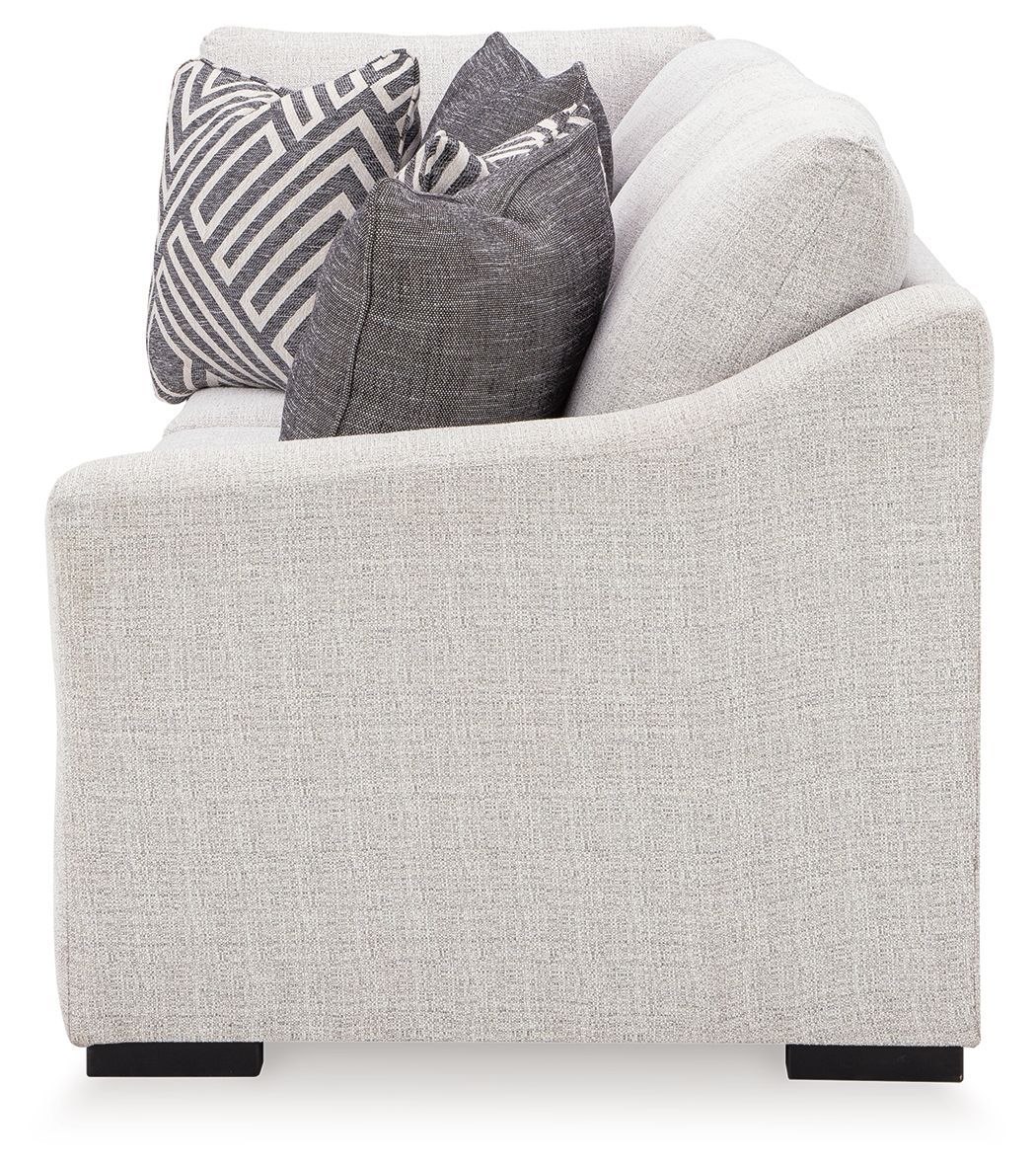 Koralynn Raf sofa arm in light gray fabric with dark legs and decorative pillows