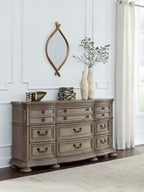 Light brown wood dresser with drawers and black knob handle pulls