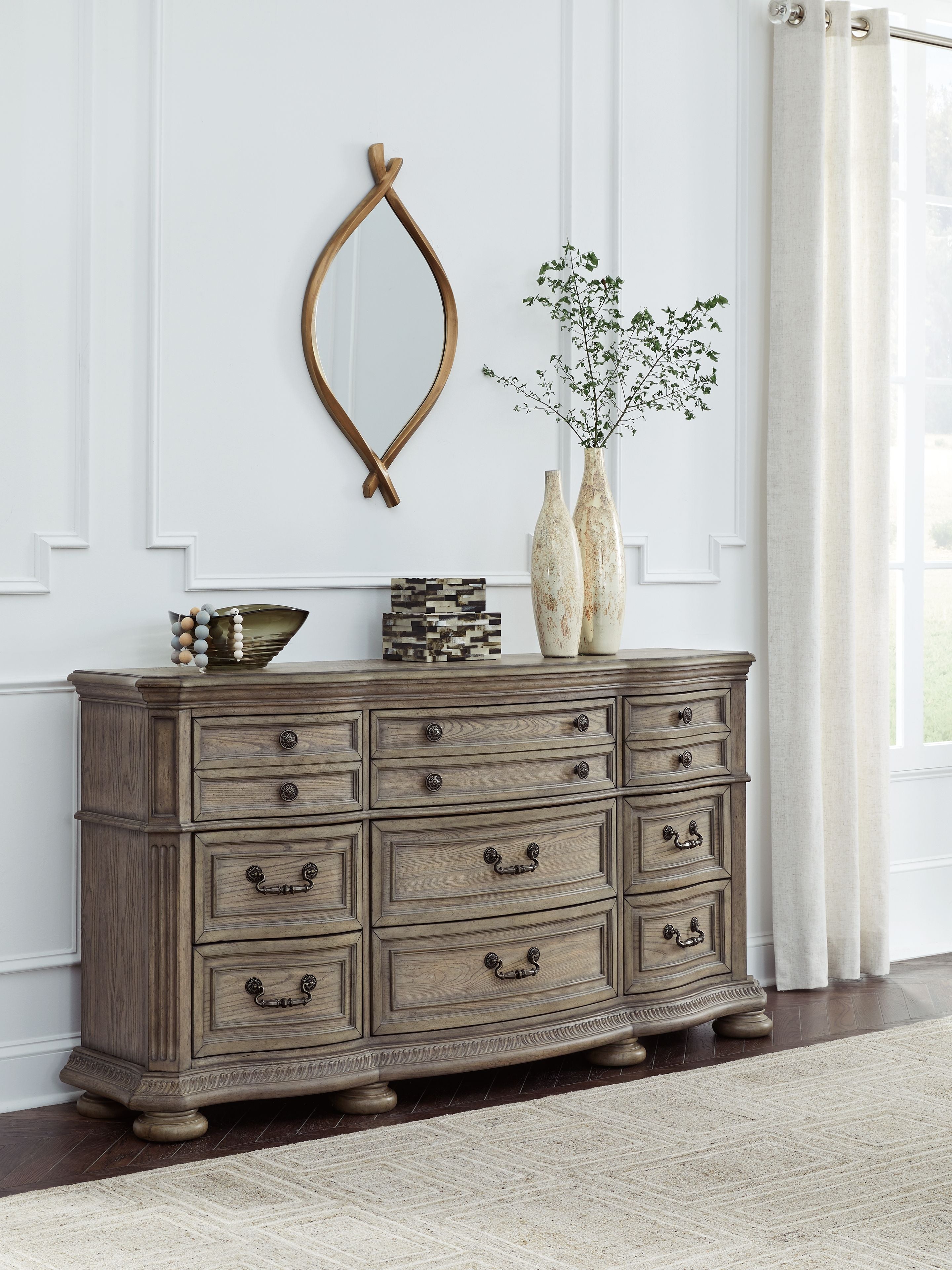 Light brown wood dresser with drawers and black knob handle pulls
