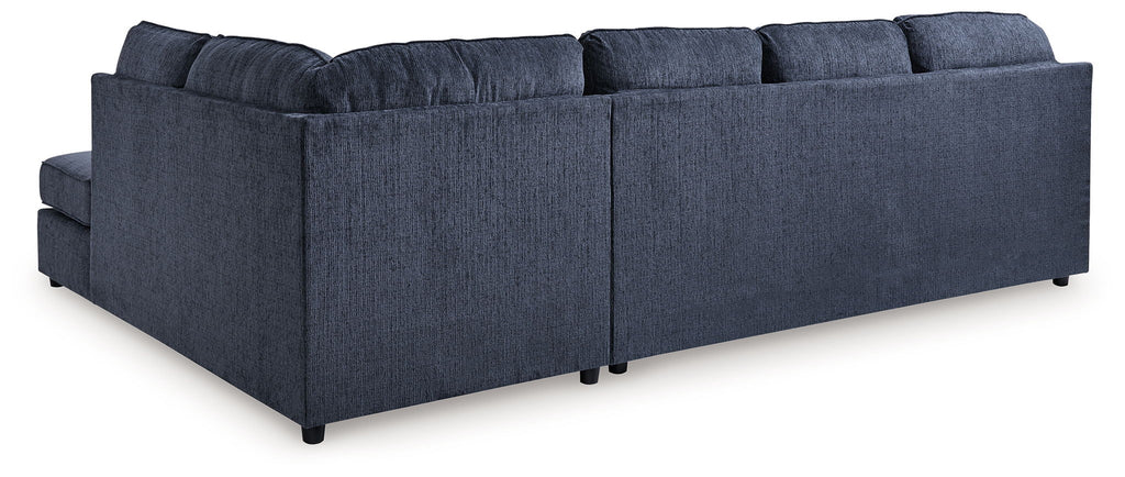 Blue sectional sofa with chaise, tufted back cushions and padded armrests