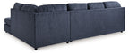 Blue sectional sofa with chaise, tufted back cushions and padded armrests