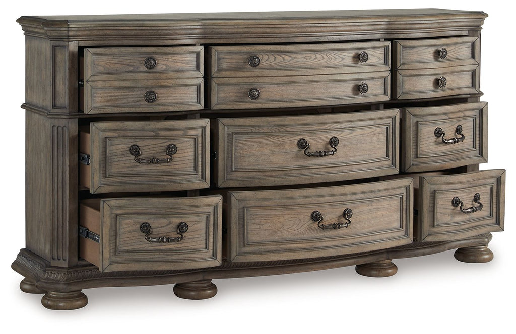 Light brown wood dresser with wide drawer fronts and black knob handle pulls