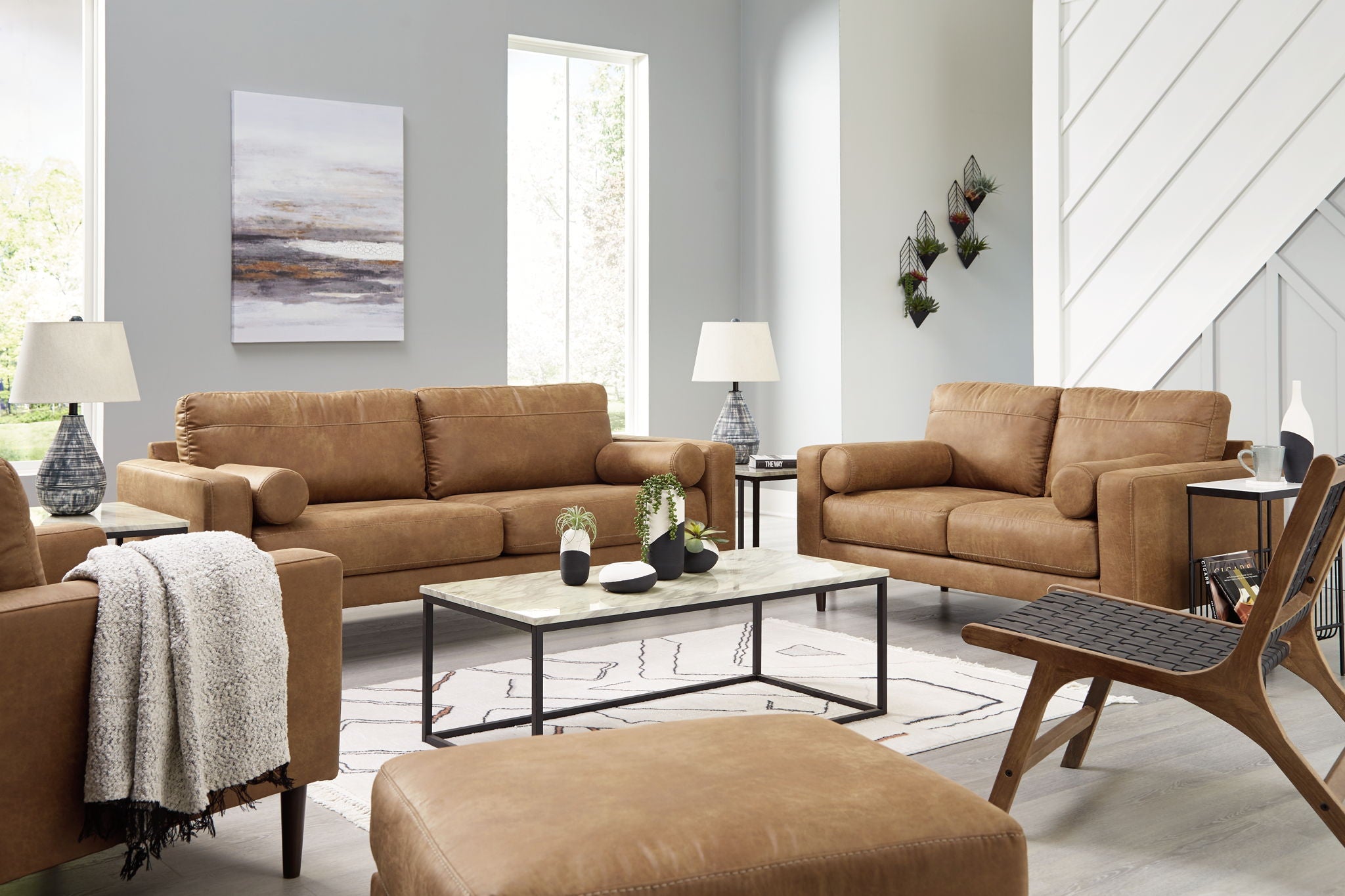 Light brown upholstered living room set with sofa, loveseat, and ottoman