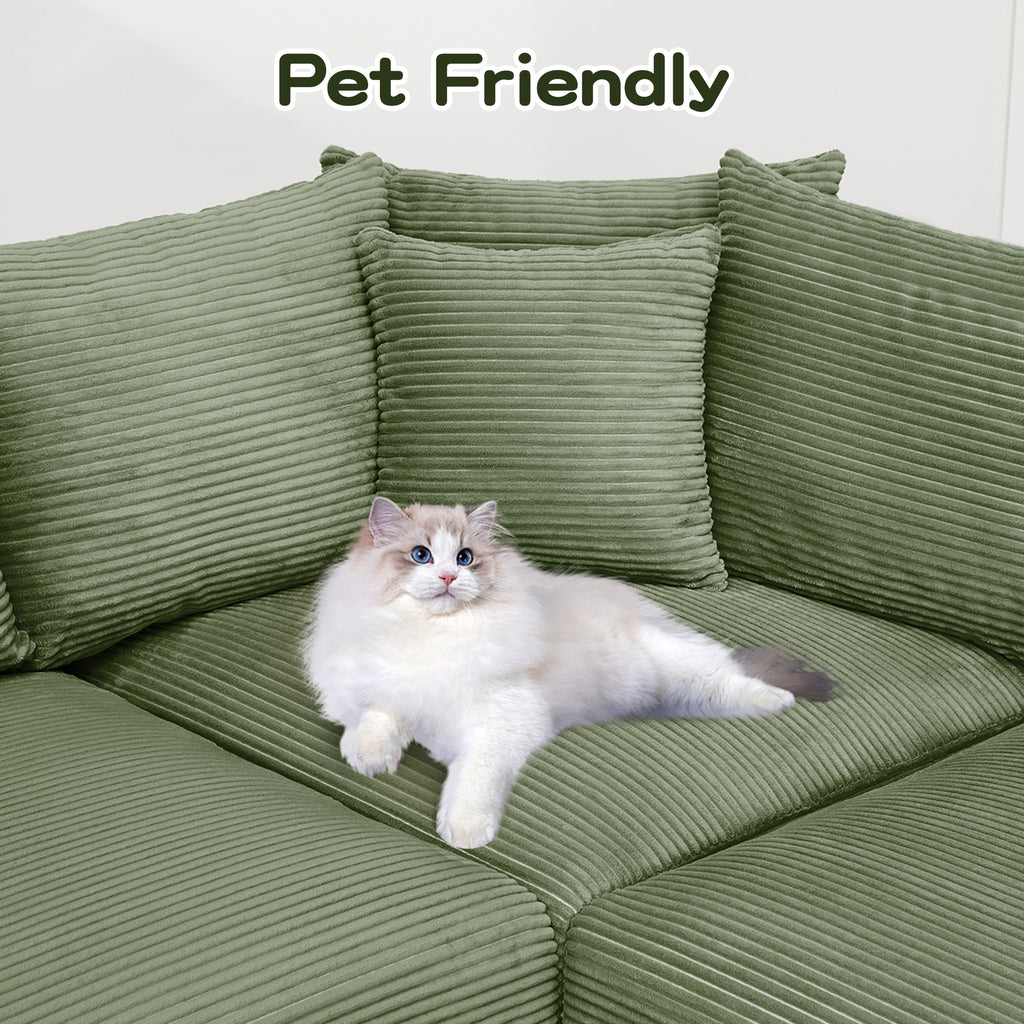 Green corduroy sofa seat with a cat resting on the cushions