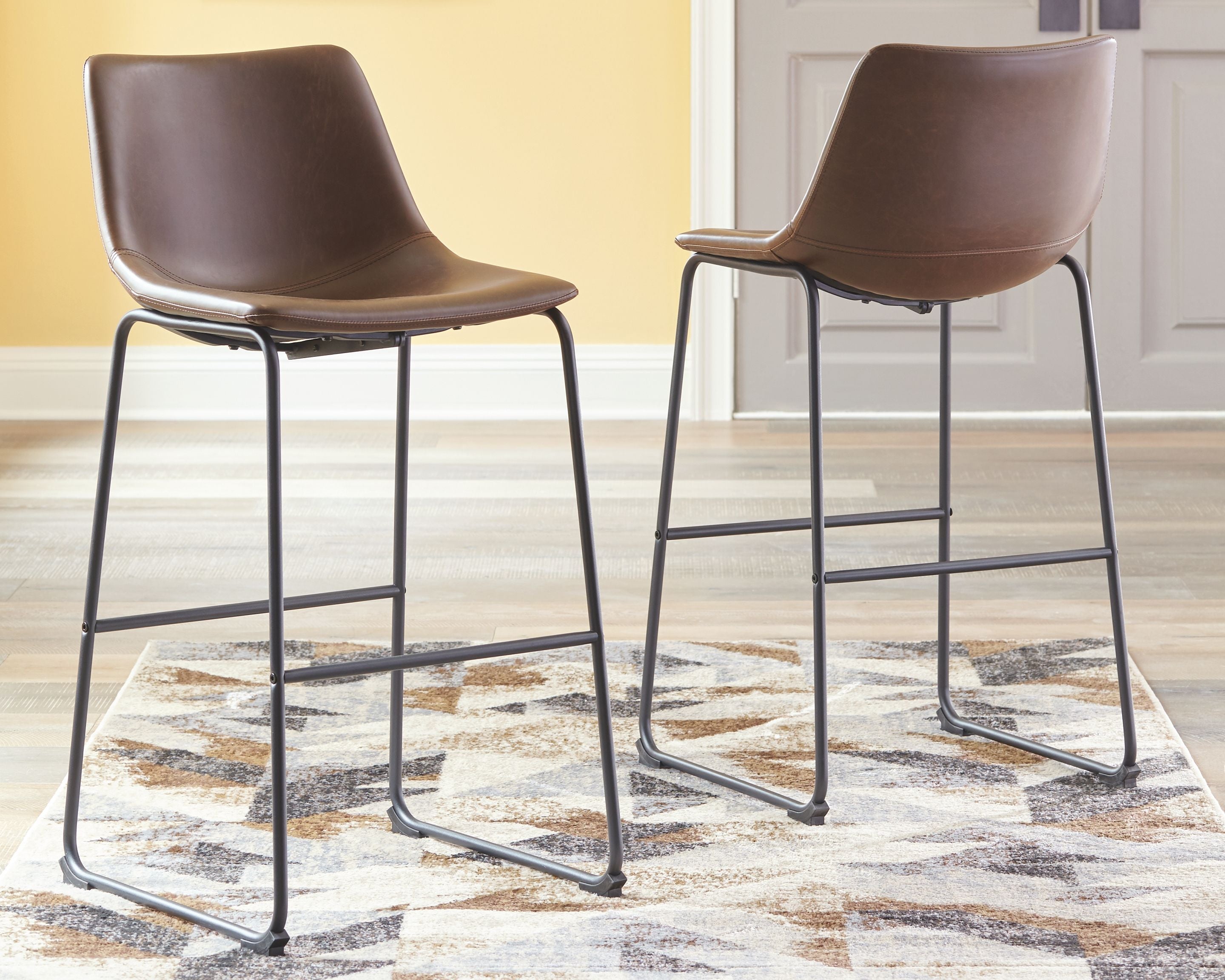 Brown upholstered barstools with curved backs and black metal frames, set of 2