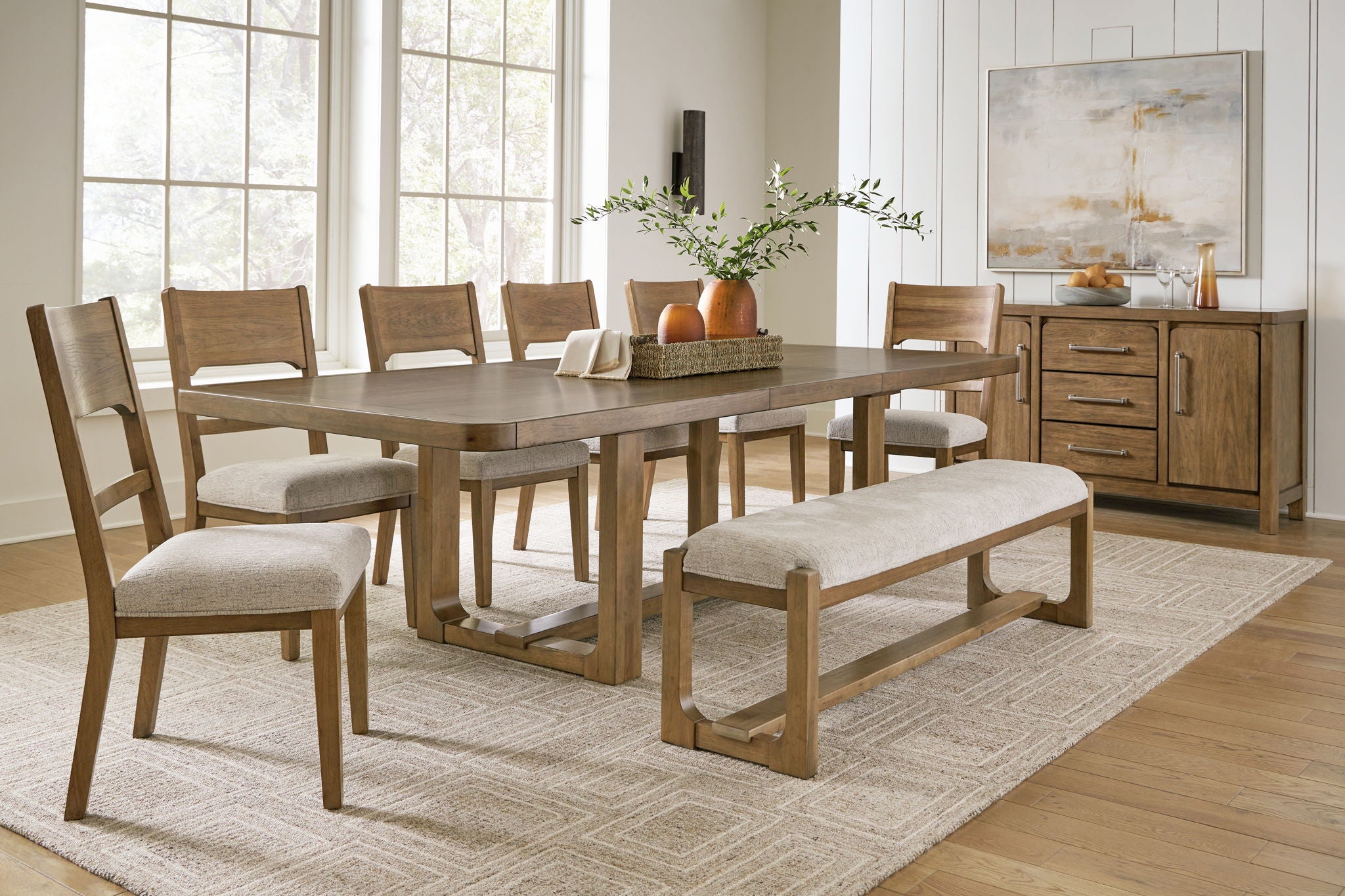Light brown dining table with upholstered benches and chairs