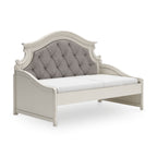 Chipped white twin day bed with tufted gray headboard and curved panel sides
