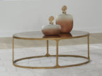 Round side table with light gray stone top and gold metal base, central pedestal