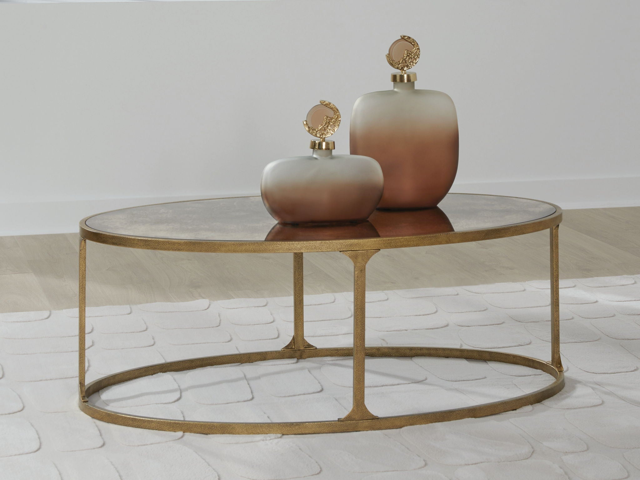 Round side table with light gray stone top and gold metal base, central pedestal
