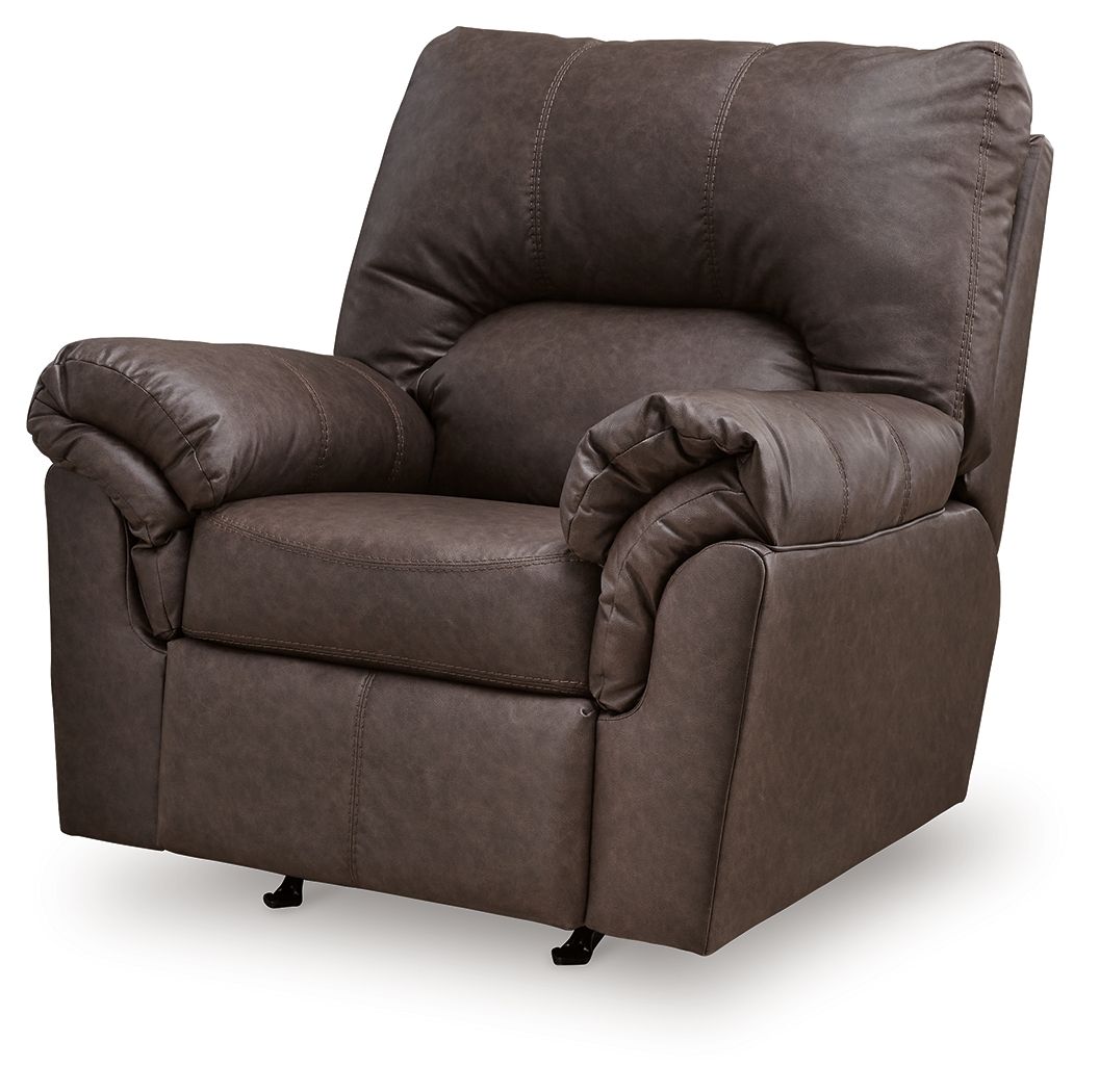 Umber upholstered rocker recliner with rounded arms, tufted back, and footrest tucked in