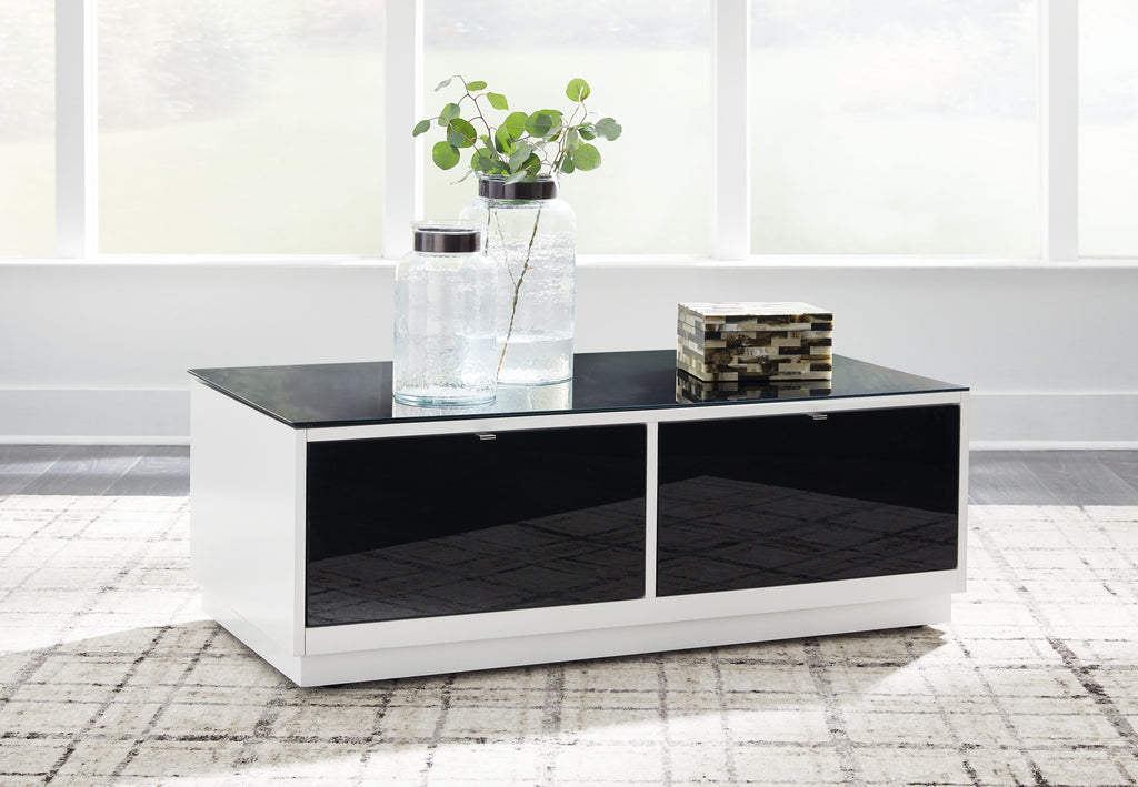 Rectangular cocktail table with white sides, two black drawers, and dark tabletop