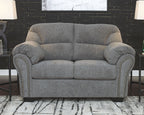 Dark gray loveseat with plush cushions, rolled arms, and studded trim along the edges