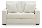 Upholstered loveseat with two seat cushions and three tall striped back pillows, light upholstery