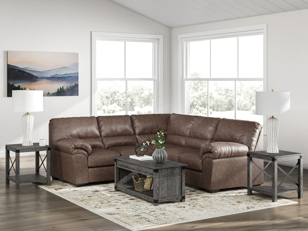 Brown sectional sofa with tufted back cushions and rolled armrests