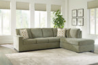 Moss green sectional sofa with chaise corner and four patterned throw pillows