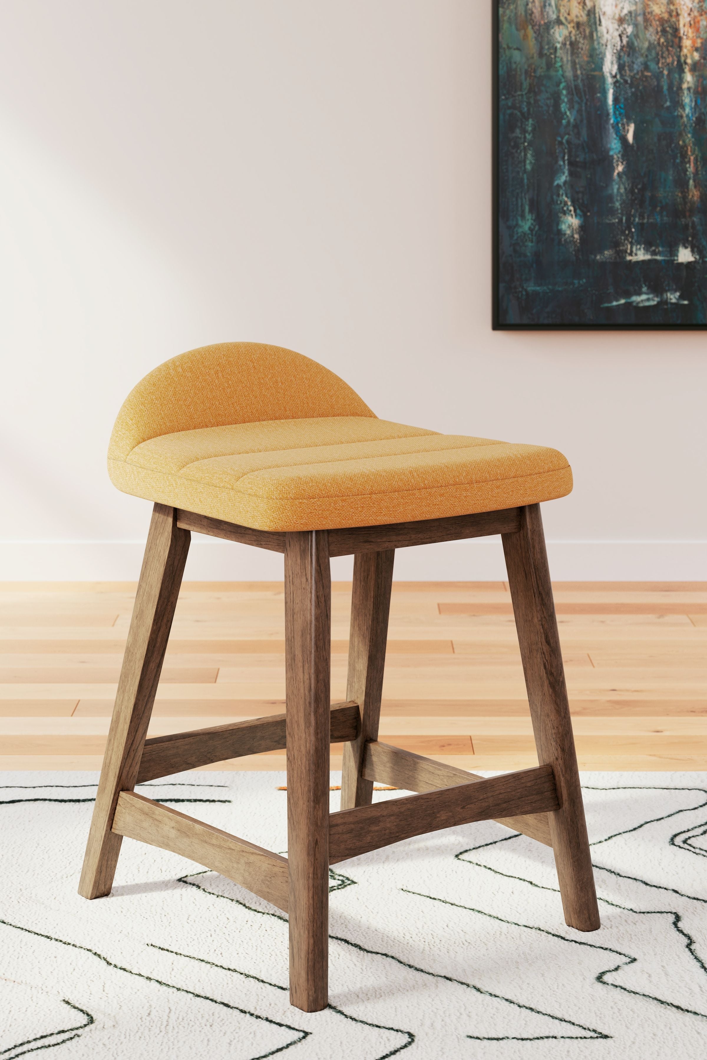 Upholstered barstool with mustard yellow fabric seat and curved back, light wood legs.