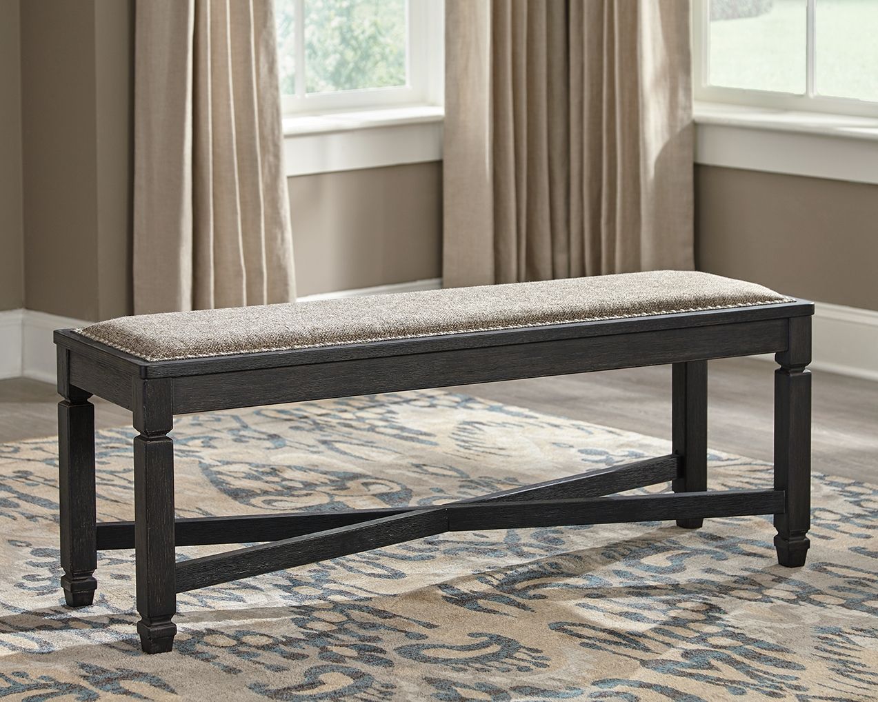 Upholstered bench with speckled beige-gray seat cushion and dark wood frame