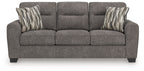 Dark gray sofa with three seat cushions and two striped lumbar pillows