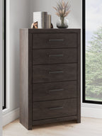 Charcoal five-drawer chest with metal bar handles; visible drawers and base.