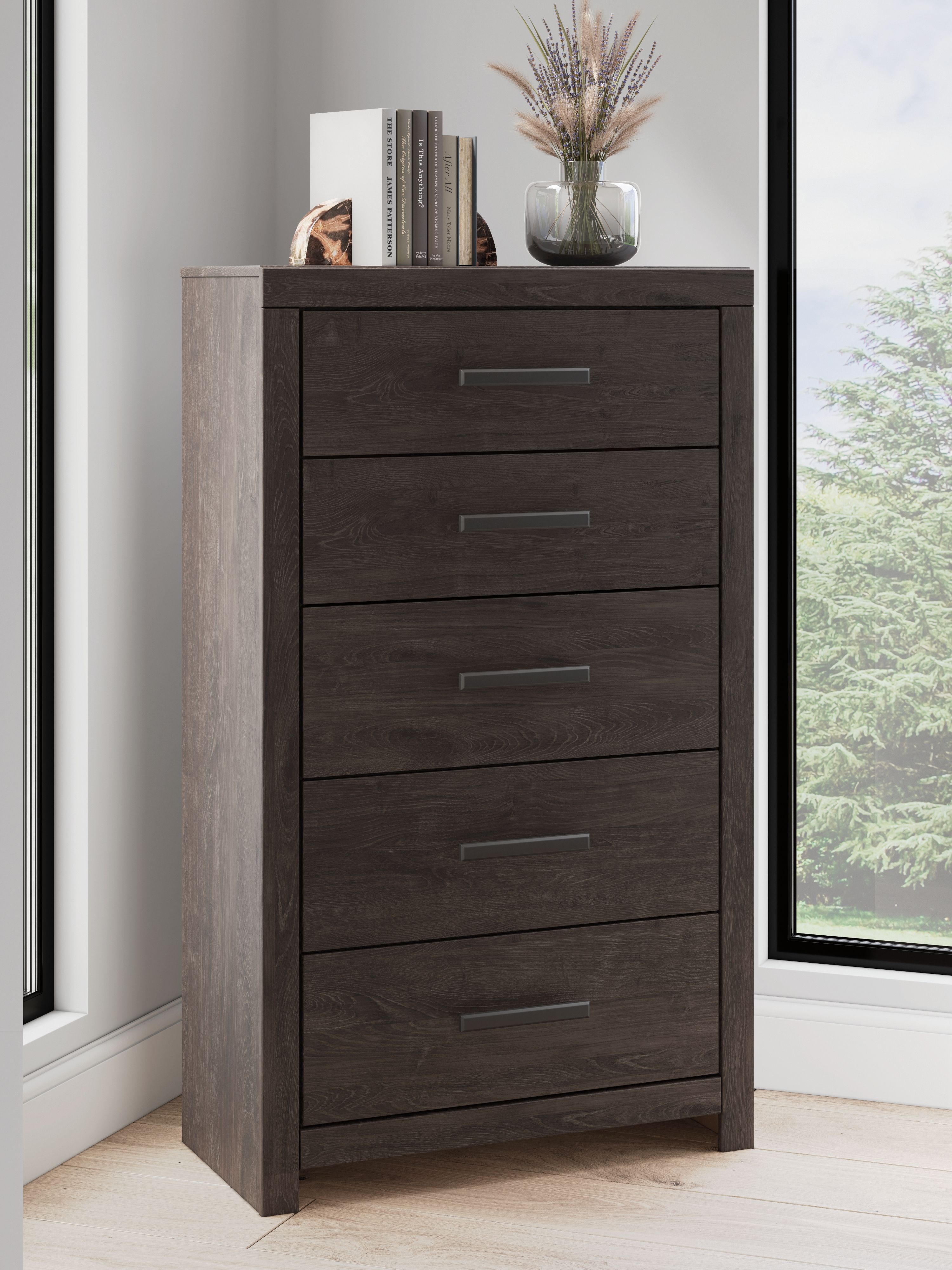 Charcoal five-drawer chest with metal bar handles; visible drawers and base.