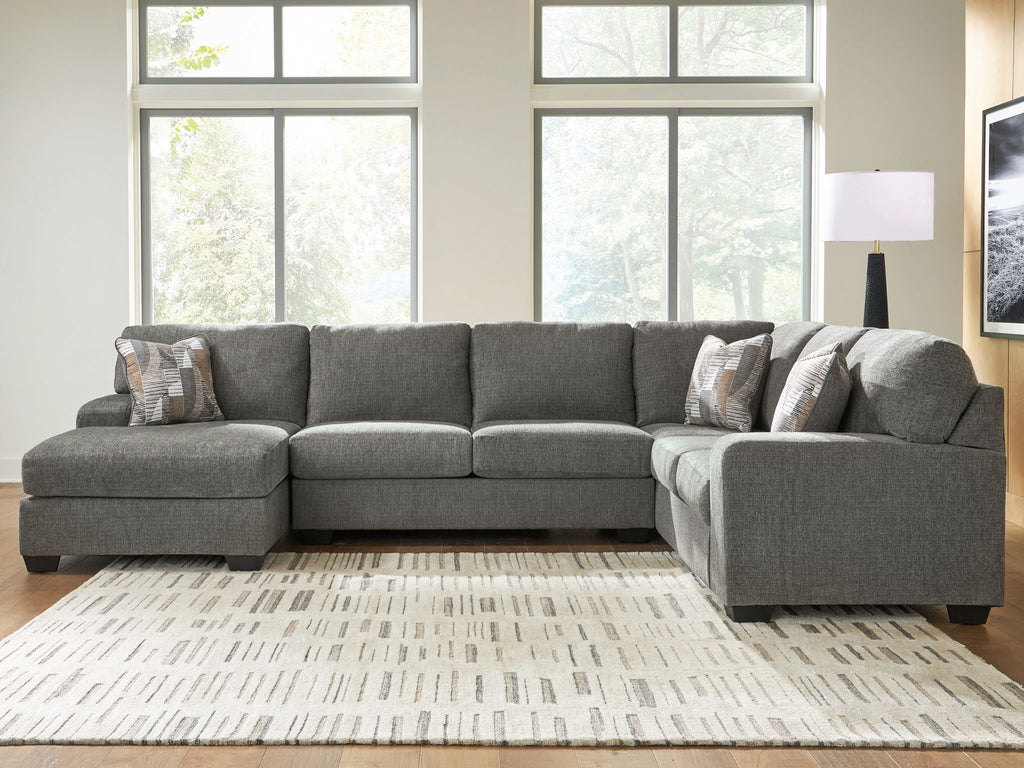 Gray sectional sofa with chaise, square arms, and multiple accent throw pillows
