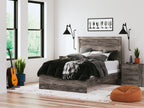 Dark gray wood-look panel bed with gray bedding and dark throw blanket