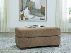 Square ottoman in light brown fabric with dark legs.