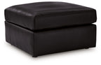 Black oversized accent ottoman with rounded edges and padded top