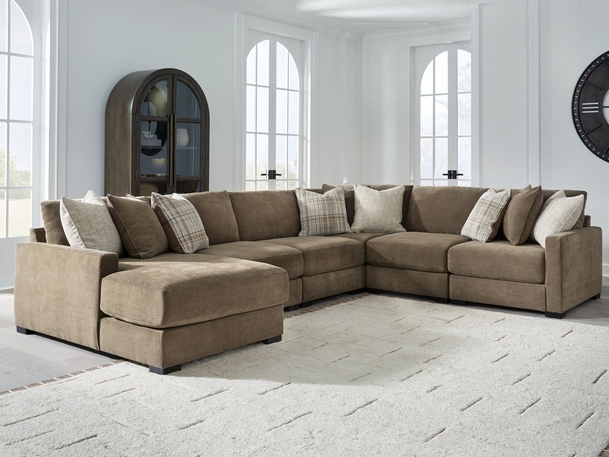 Coffee-brown sectional sofa with chaise, wide track arms, and mixed throw pillows