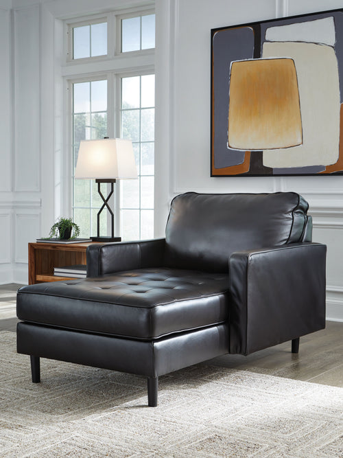 Onyx black leather chaise chair with wide arms and tufted seat, dark legs