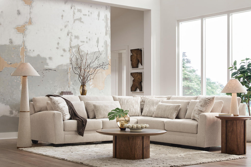 Light beige sectional sofa with chaise corner and patterned throw pillows