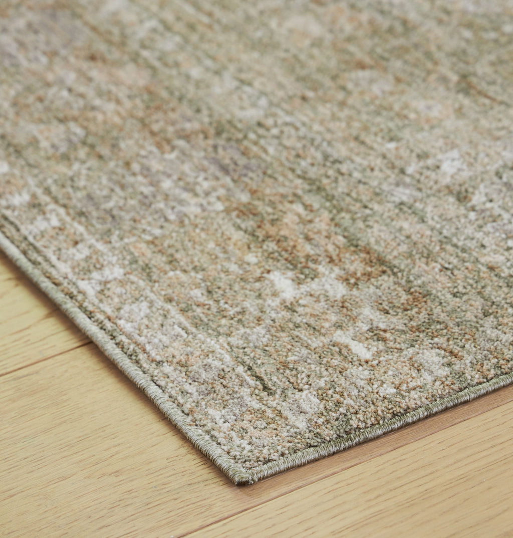 Corner view of light brown flatweave rug with distressed speckled fibers