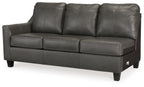 Dark gray leather sofa with three back cushions, three seat cushions, and tapered legs