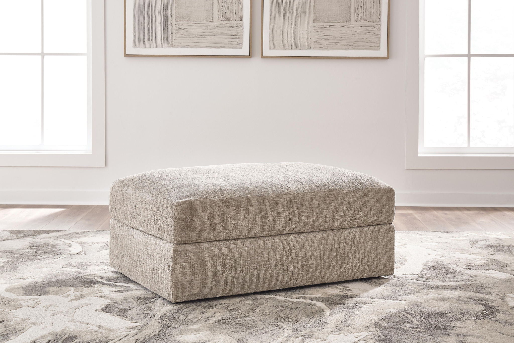 Oversized ottoman with rounded top, burlap-style beige fabric upholstery and short legs