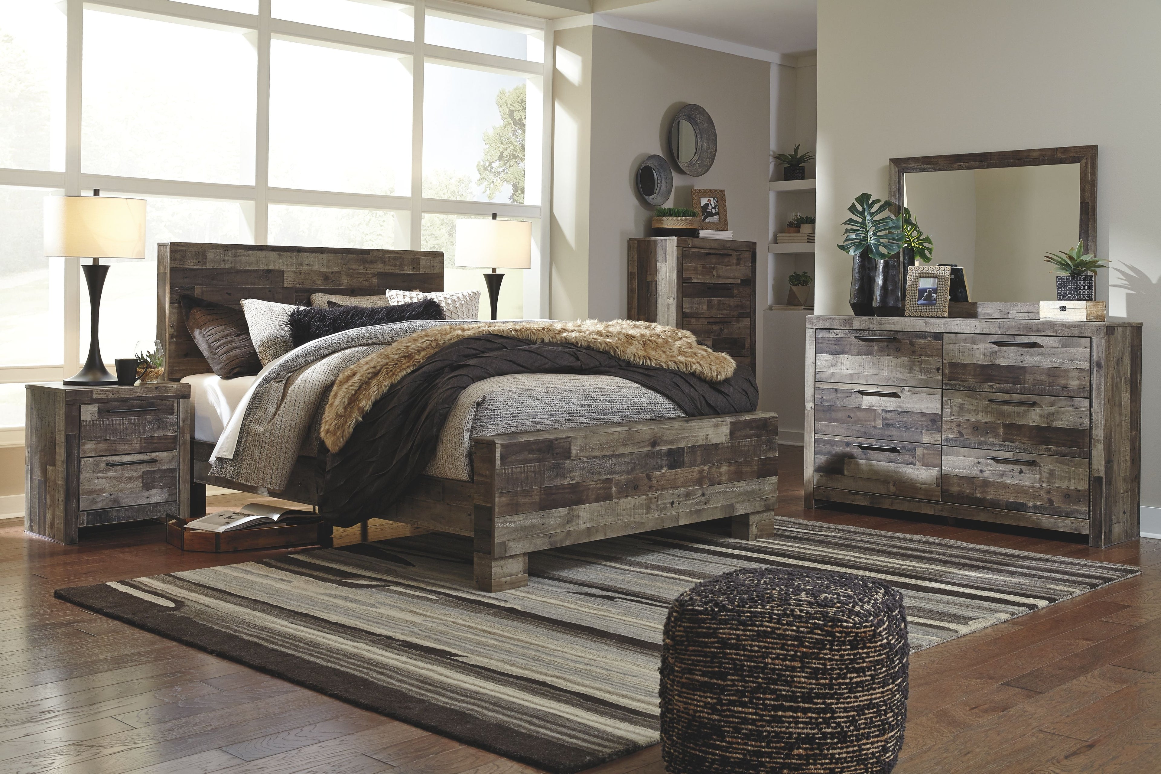 Panel bedroom set with panel bed, nightstand, dresser, and mirror in rustic gray wood.