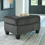 Gray ottoman with square top, upholstered sides, and dark block legs