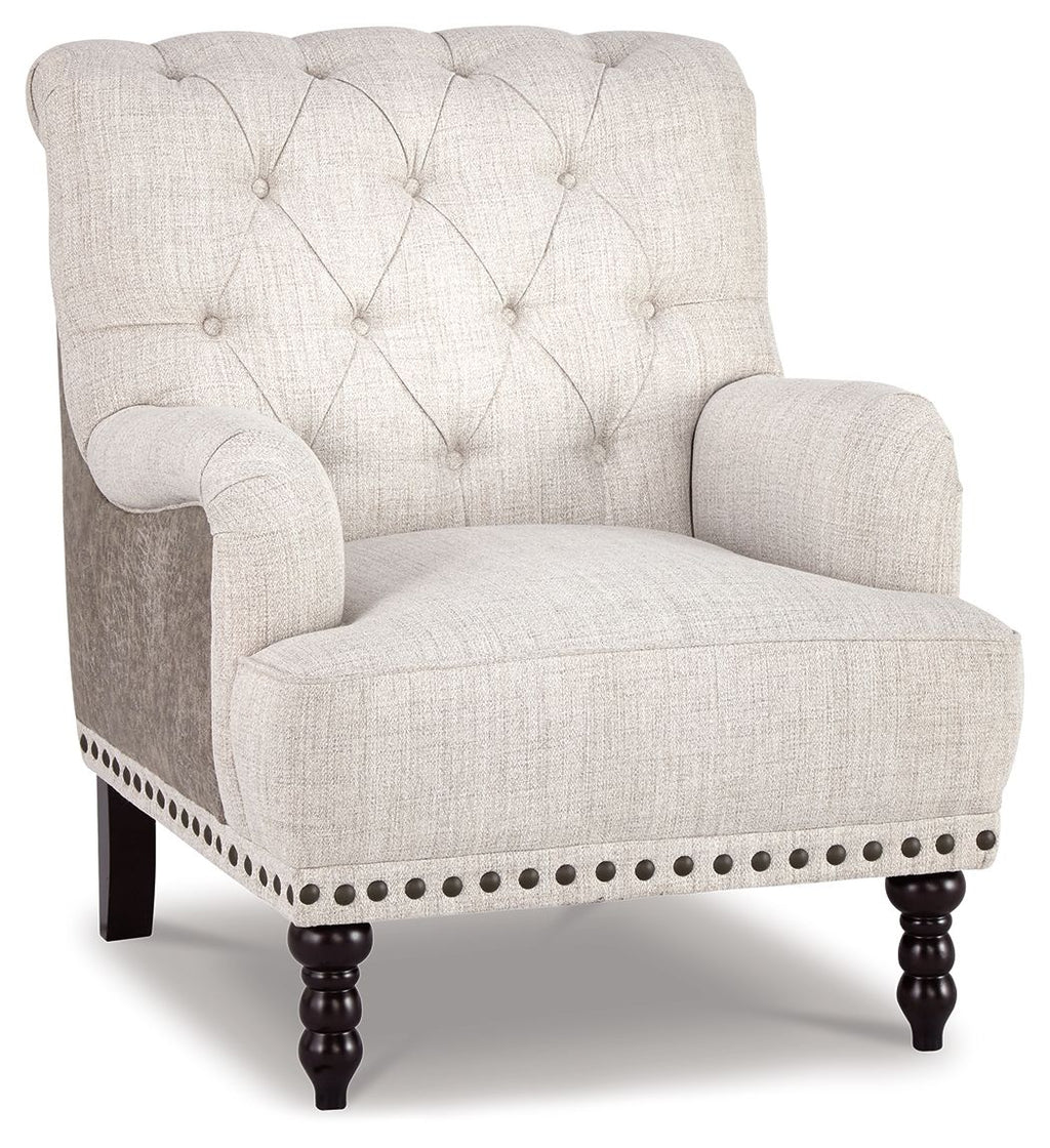 Upholstered accent chair in light gray fabric with tufted back and nailhead trim on arms