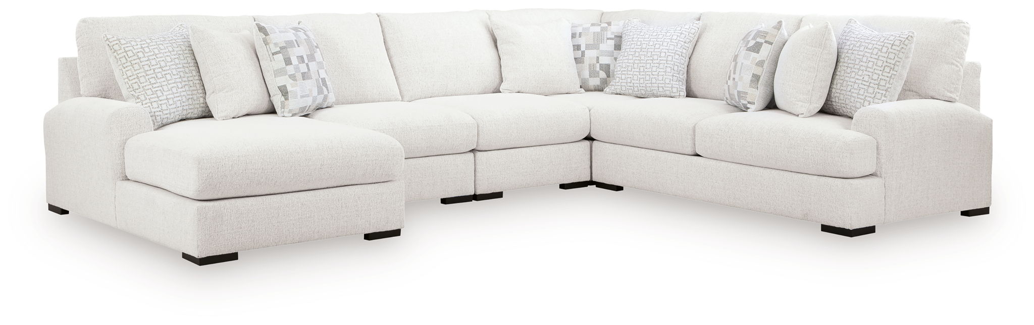 Light beige sectional sofa with chaise-style ottoman and decorative throw pillows