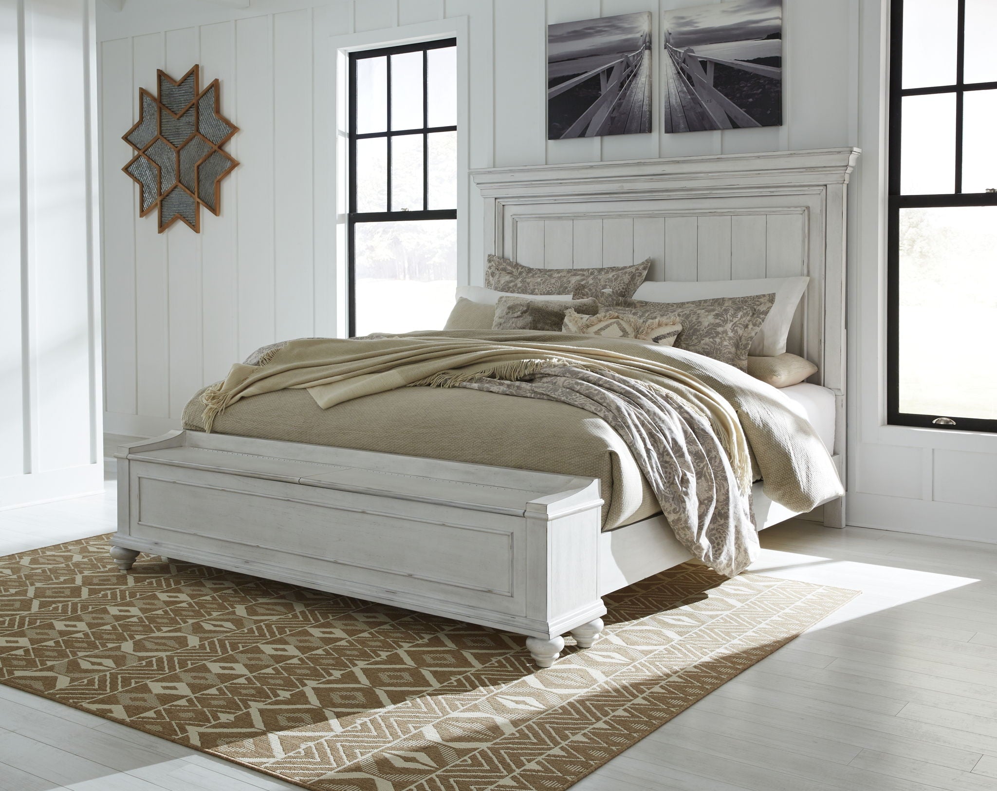 White panel bed with tall headboard and footboard, styled with pillows and a throw.