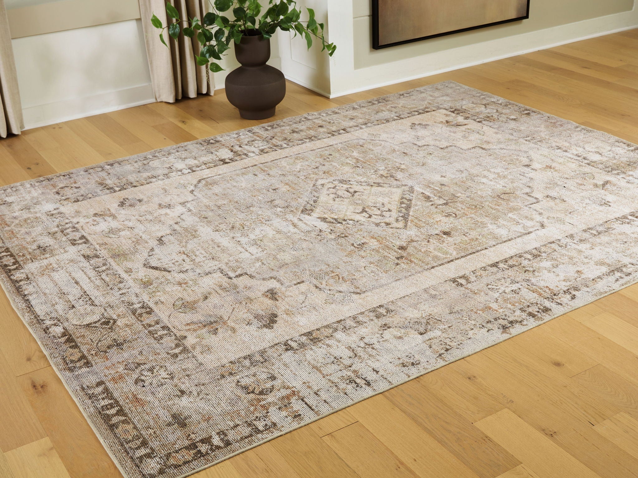 Washable rug with distressed geometric pattern, central medallion, and border