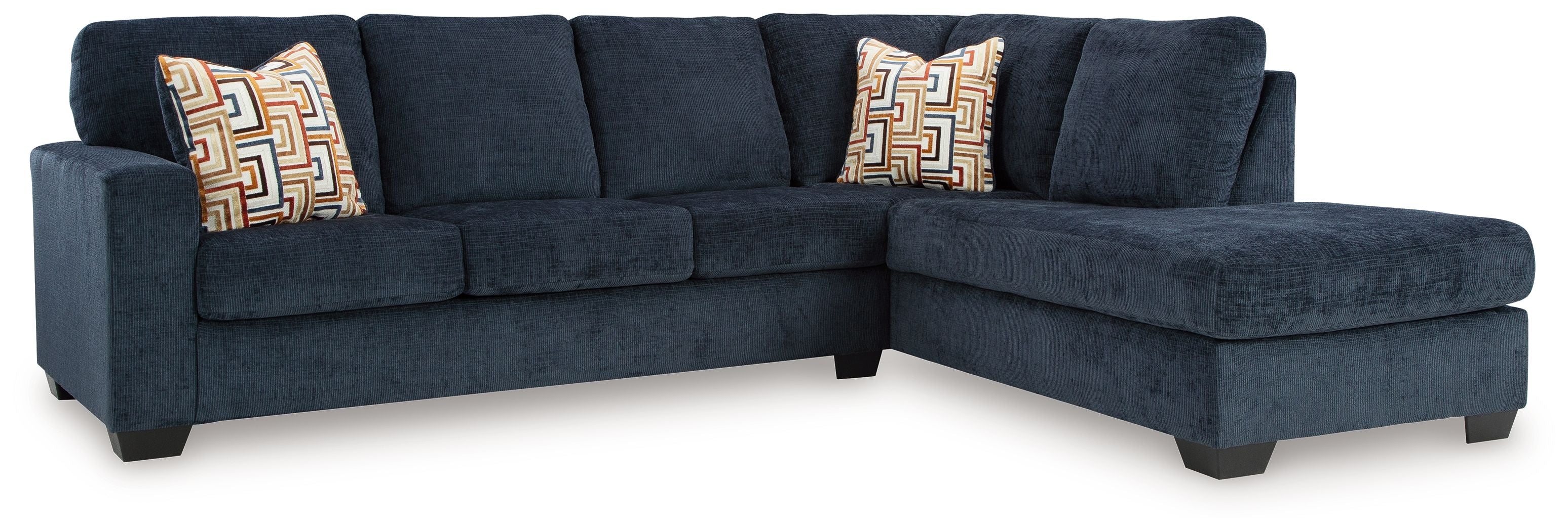Dark blue sectional sofa with corner chaise and three geometric accent cushions